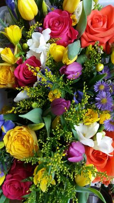 Cluster of spring table centerpieces, yellows, pinks, oranges and purples